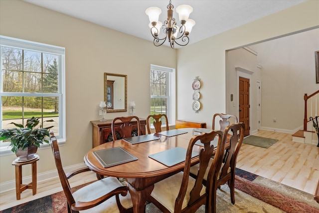 dining room with an inviting chandelier and hardwood / wood-style floors