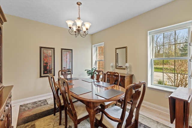 dining space featuring hardwood / wood-style floors and a chandelier