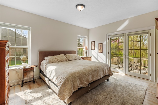 bedroom with light hardwood / wood-style flooring and access to exterior