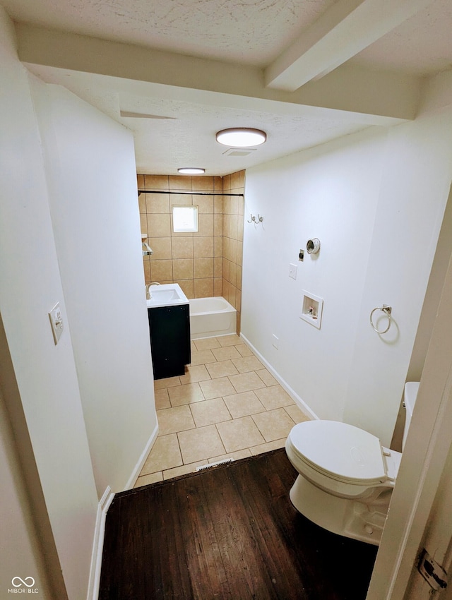 full bathroom with tile patterned floors, vanity, toilet, and tiled shower / bath combo