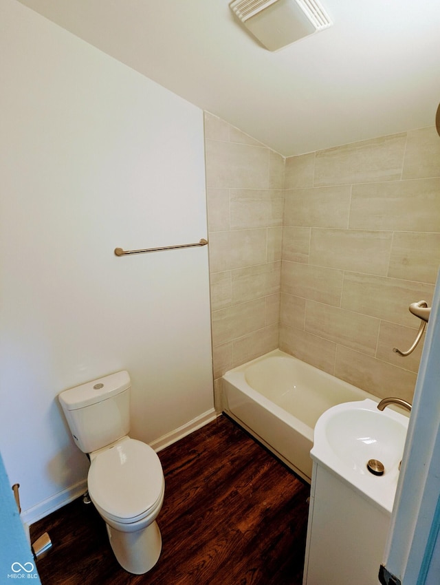 bathroom with toilet, vanity, and hardwood / wood-style flooring