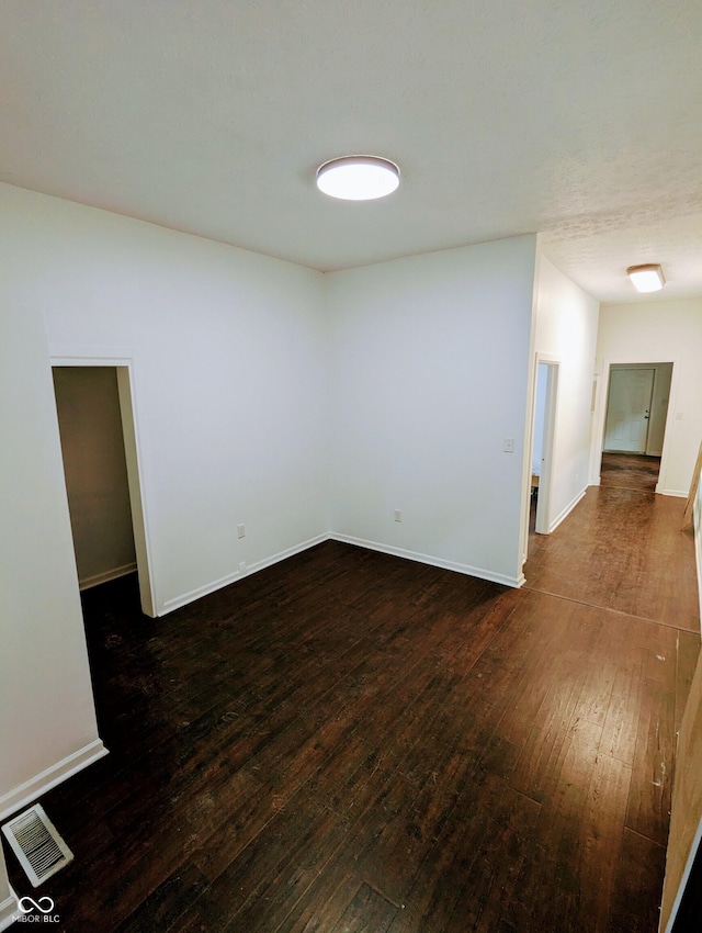 unfurnished room featuring dark hardwood / wood-style flooring