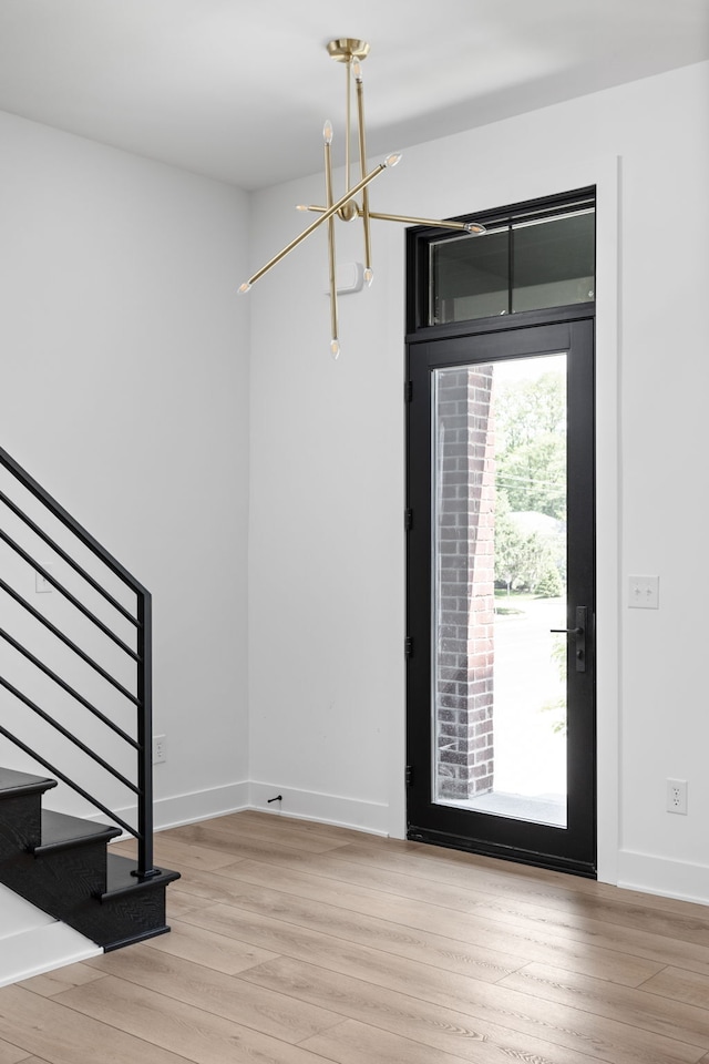 entrance foyer featuring an inviting chandelier and light hardwood / wood-style floors