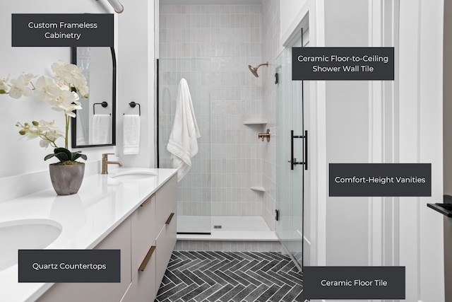 bathroom featuring a shower with door, tile floors, and dual vanity