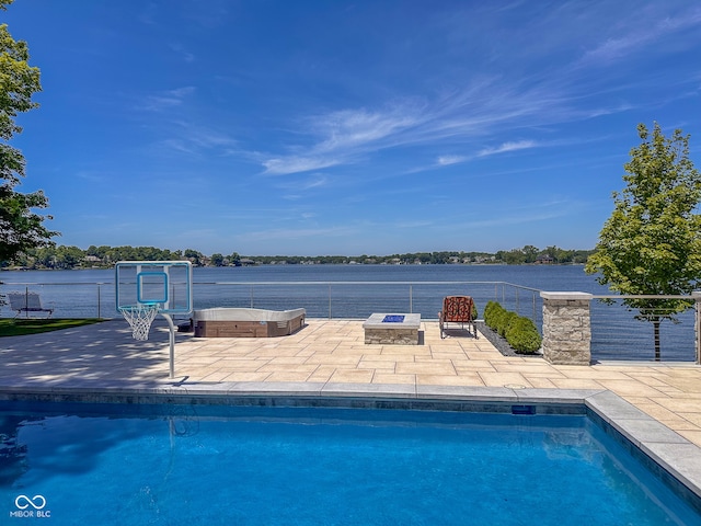 view of swimming pool featuring a patio area and a fire pit