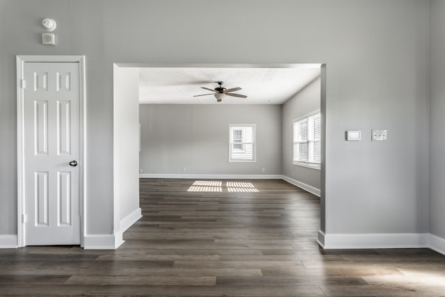 unfurnished room with dark hardwood / wood-style floors and ceiling fan