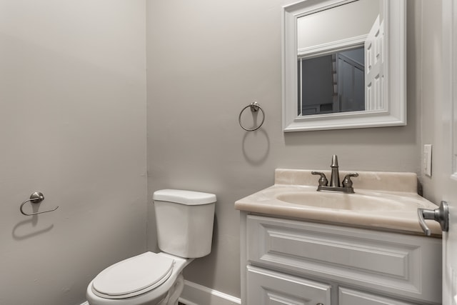 bathroom with toilet and large vanity