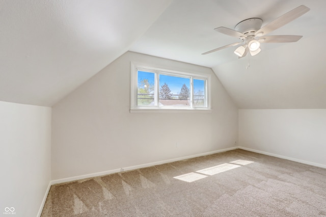 additional living space with lofted ceiling, light colored carpet, and ceiling fan