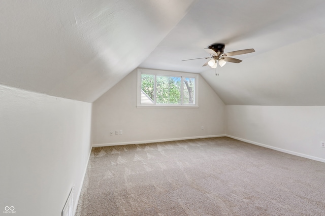 bonus room featuring vaulted ceiling, light colored carpet, and ceiling fan