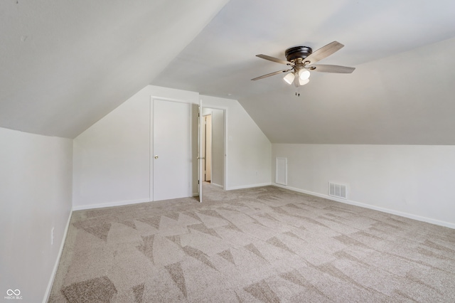 additional living space with light carpet, ceiling fan, and lofted ceiling