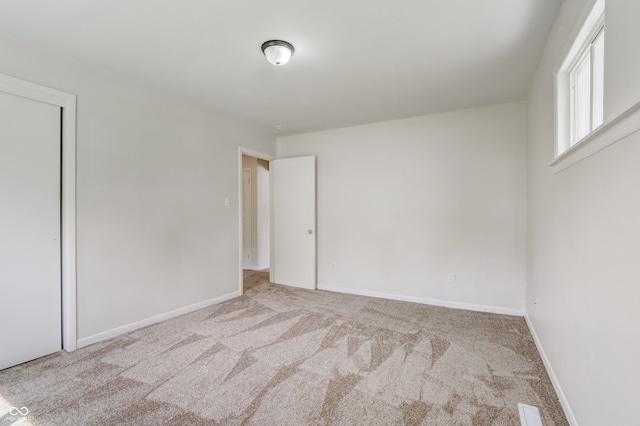 empty room featuring light carpet