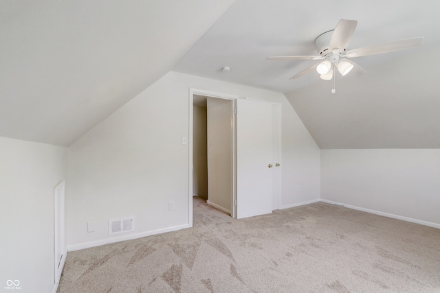 additional living space featuring light carpet, ceiling fan, and lofted ceiling