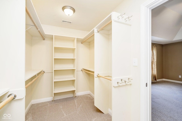 spacious closet featuring light carpet