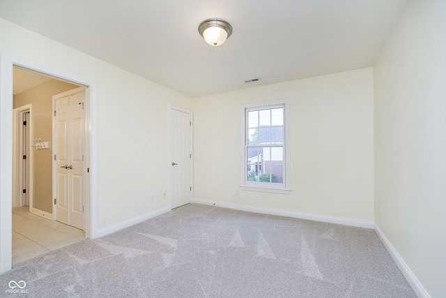 empty room featuring light carpet