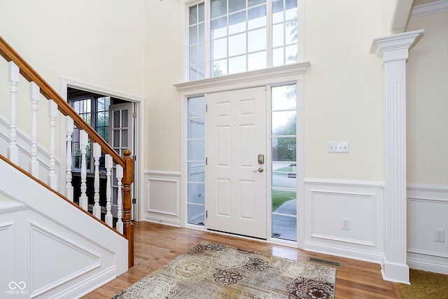 entrance foyer featuring light hardwood / wood-style flooring and a high ceiling