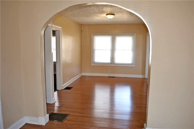 empty room with hardwood / wood-style flooring