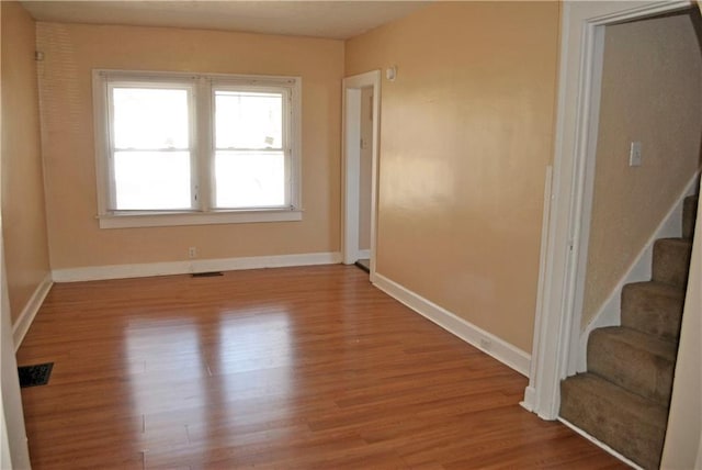 unfurnished room featuring wood-type flooring