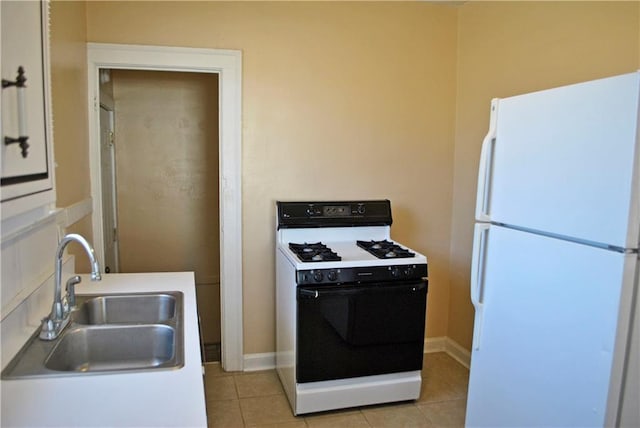 kitchen with sink, white appliances, and light tile floors