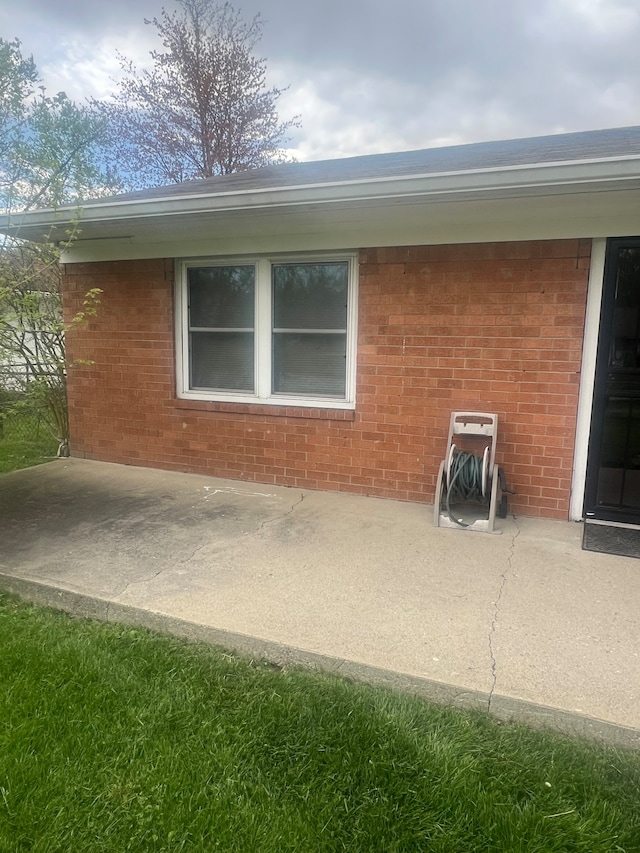 view of side of home with a patio