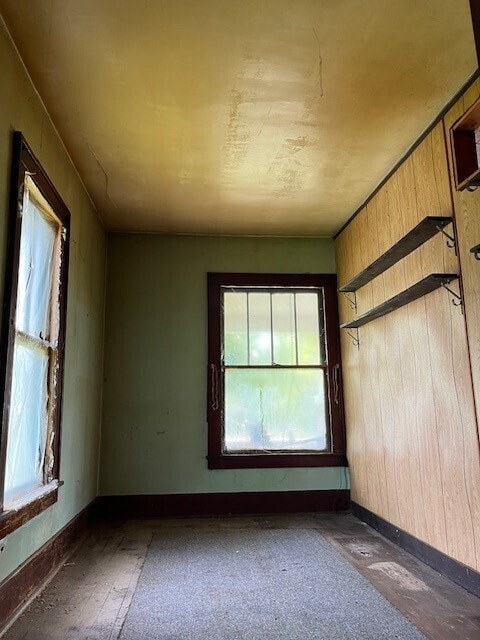 empty room featuring wooden walls