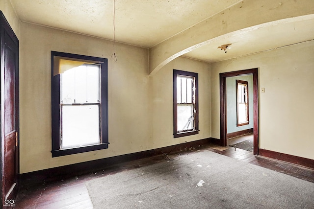 empty room featuring dark hardwood / wood-style flooring