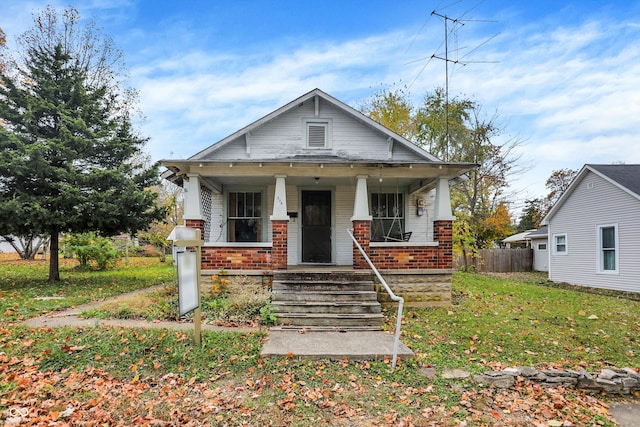 bungalow-style home with a porch and a front yard