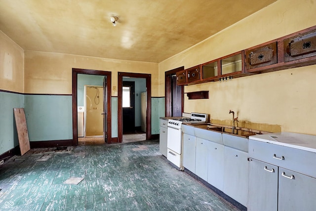 kitchen featuring gas range gas stove and white cabinets