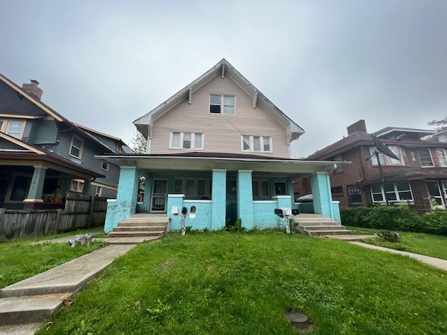 view of front of house featuring covered porch and a front lawn