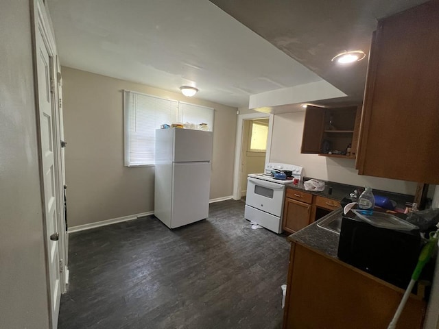 kitchen featuring dark hardwood / wood-style floors and white appliances