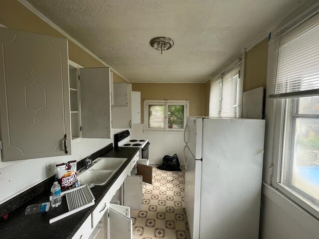 kitchen featuring white cabinets, sink, white appliances, and tile floors