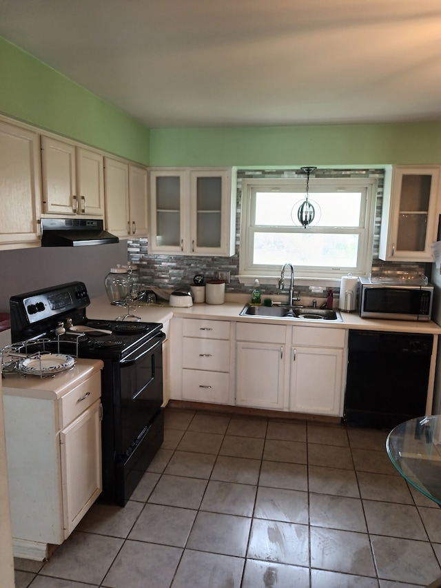 kitchen featuring white cabinets, black appliances, backsplash, light tile floors, and sink