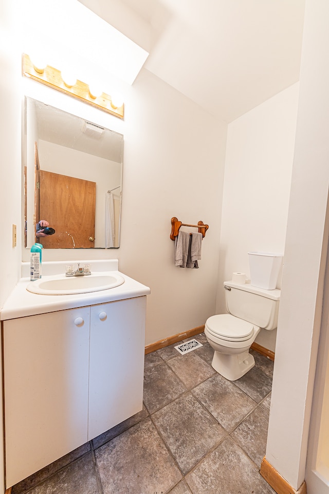 bathroom featuring toilet and vanity