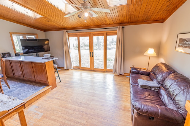 living room with ceiling fan, wooden ceiling, vaulted ceiling with skylight, and light hardwood / wood-style floors