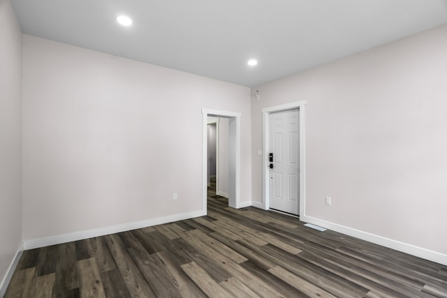 empty room with dark hardwood / wood-style floors