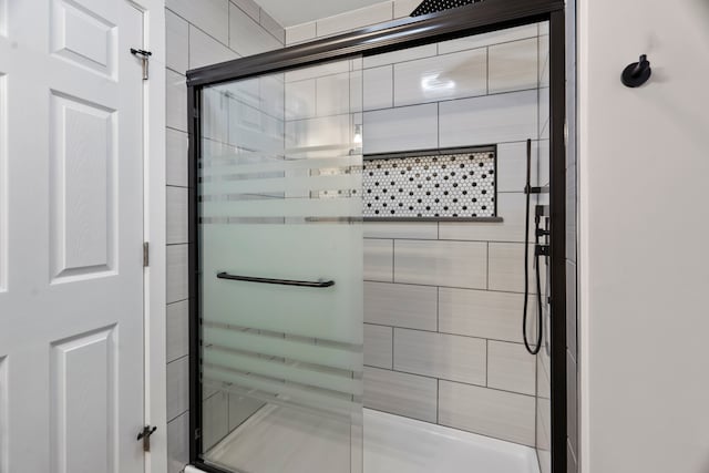 bathroom with a shower with shower door