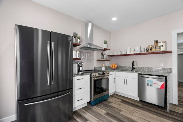 kitchen with wall chimney exhaust hood, dark hardwood / wood-style flooring, white cabinetry, appliances with stainless steel finishes, and sink