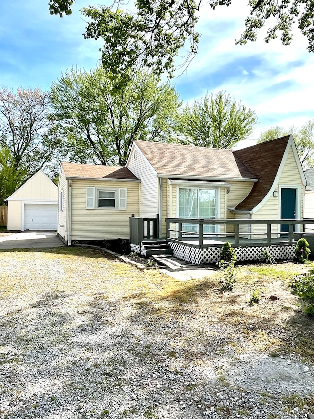 view of front of house featuring an outbuilding, a garage, and a wooden deck