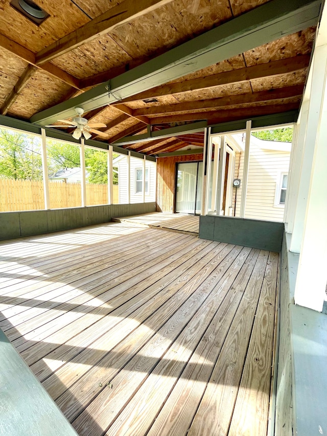 unfurnished sunroom with ceiling fan and lofted ceiling