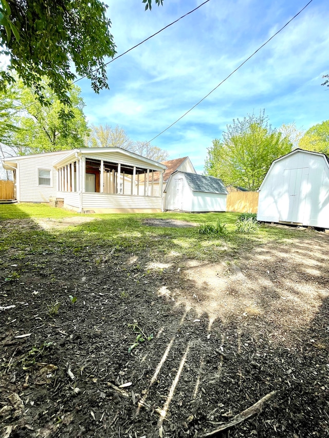 view of yard featuring a storage shed and a sunroom