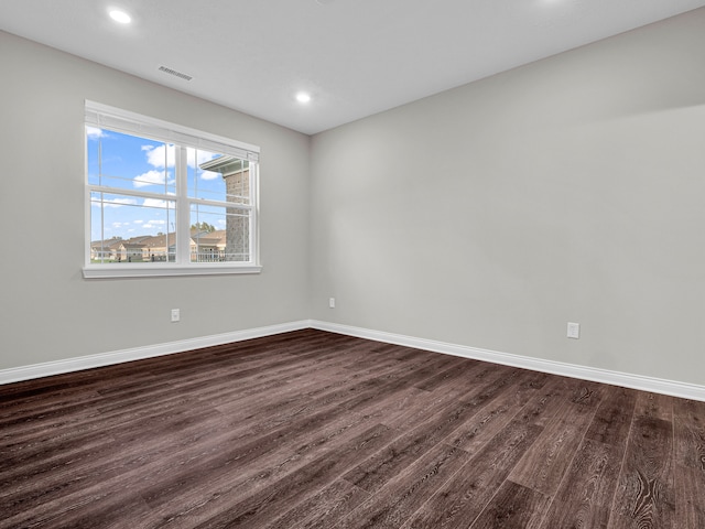 spare room with dark wood-type flooring