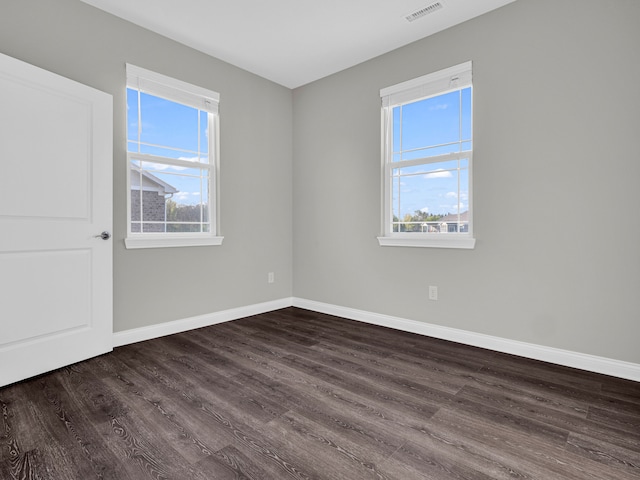 spare room featuring dark hardwood / wood-style flooring