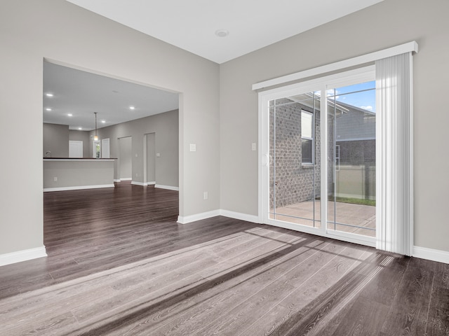 spare room featuring dark hardwood / wood-style floors