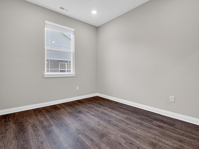 spare room featuring dark hardwood / wood-style flooring