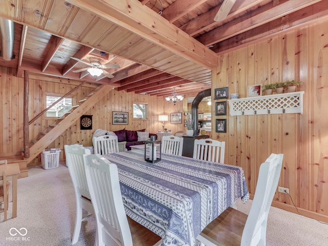 6486 Coyote Dr, Nineveh, IN 46164 - dining space featuring wooden walls, beam ceiling, carpet floors, stairway, and a ceiling fan