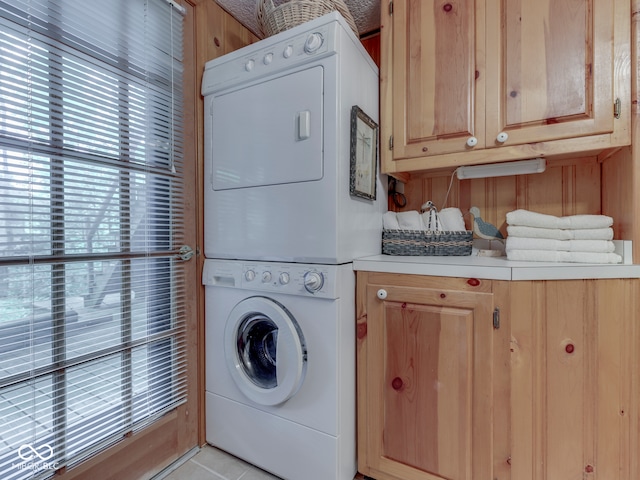6486 Coyote Dr, Nineveh, IN 46164 - clothes washing area with stacked washer and clothes dryer and cabinet space