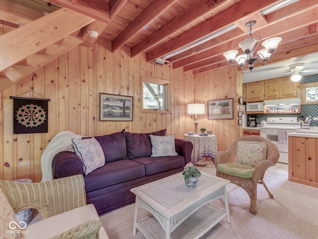6486 Coyote Dr, Nineveh, IN 46164 - living room featuring a chandelier, beam ceiling, light colored carpet, and wooden walls