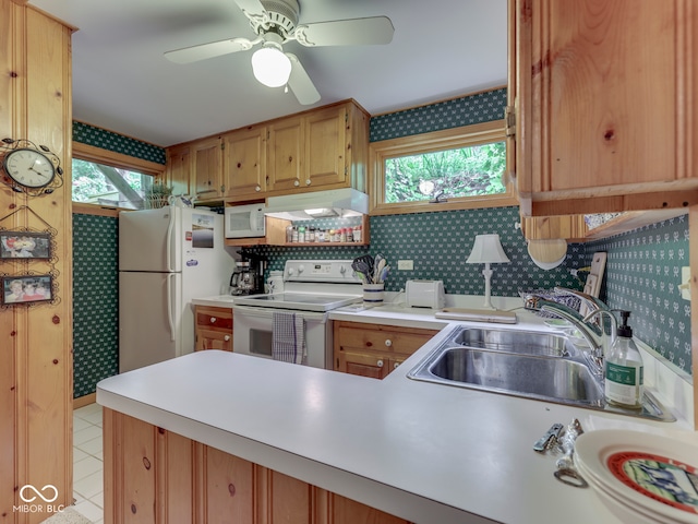 6486 Coyote Dr, Nineveh, IN 46164 - kitchen with white appliances, under cabinet range hood, a sink, wallpapered walls, and a peninsula