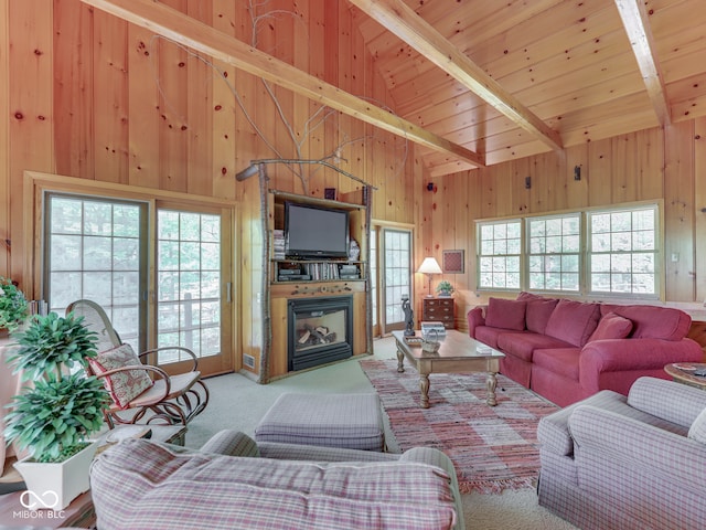 6486 Coyote Dr, Nineveh, IN 46164 - carpeted living room featuring beamed ceiling, wood walls, a glass covered fireplace, high vaulted ceiling, and wooden ceiling