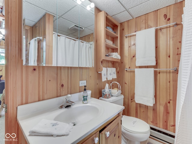 6486 Coyote Dr, Nineveh, IN 46164 - bathroom with a baseboard heating unit, wood walls, vanity, toilet, and a shower with shower curtain