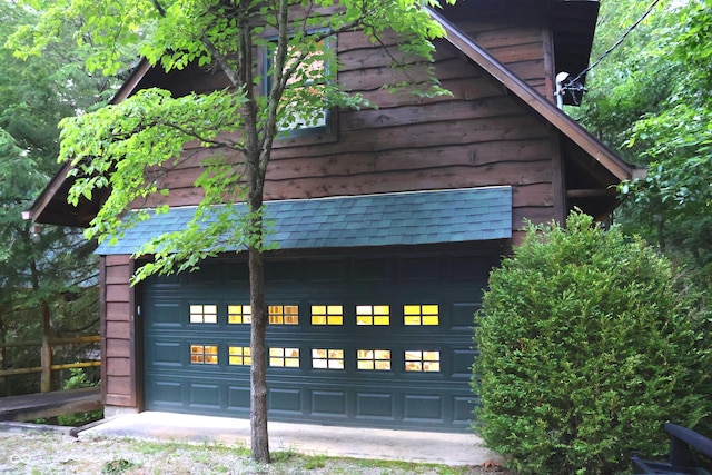 6486 Coyote Dr, Nineveh, IN 46164 - view of side of property with a garage and roof with shingles